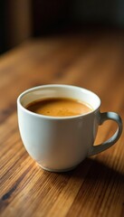 Obraz premium Warm golden liquid in a white ceramic mug on a wooden table, warmth, wood