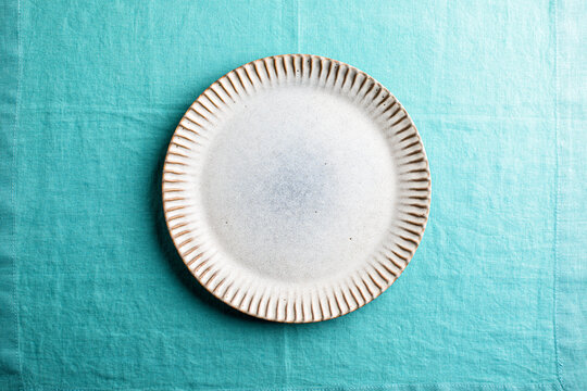 plate on aqua linen , overhead