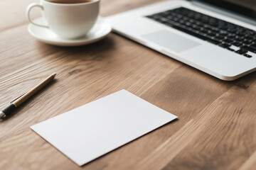 Coffee on wooden table next to laptop with blank card and pen for notes