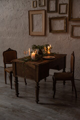Wooden retro table with vintage chairs and candles