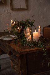Table setting with glasses, plate and candles