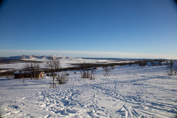 Stunning sunset view over Kiruna city and mine with snow covered trees in Swedish Lapland