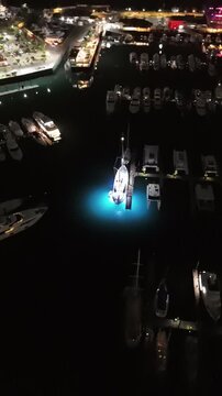 Cinematic aerial view from a drone at night on the Amador Causeway in Panama City, Vertical 4K Video
