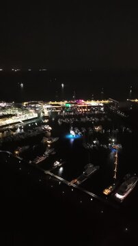 Cinematic aerial view from a drone at night on the Amador Causeway in Panama City, Vertical 4K Video