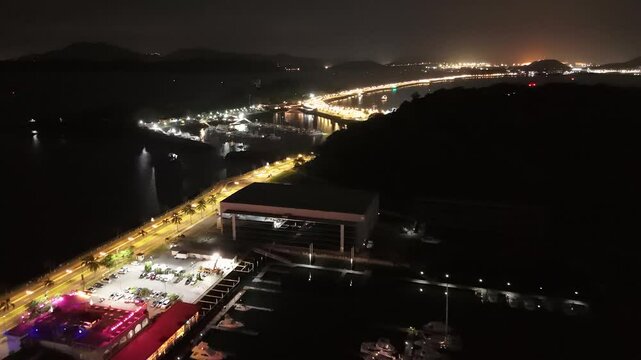 Cinematic aerial view from a drone at night on the Amador Causeway in Panama City, 4K Video