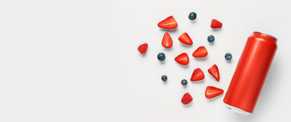 Composition with can of fresh soda and berries on white background