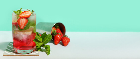 Glass of delicious strawberry mojito on color background, closeup