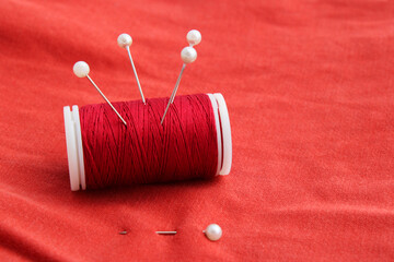Sewing pins on a spool of thread