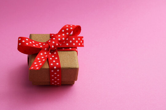 Gift box with red ribbon bow with white dots