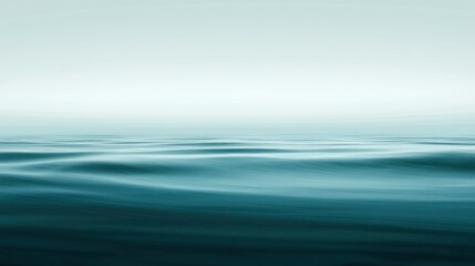 Serene water surface with soft waves and a slightly overcast sky