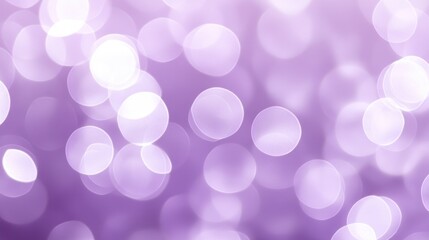 A blurry background of luminous bokeh light circles on purple