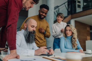 Business team analyzing financial data in modern office
