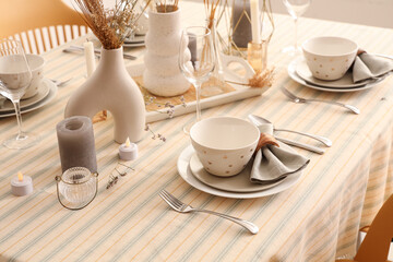 Elegant table setting with folded napkins, bowls and cutlery