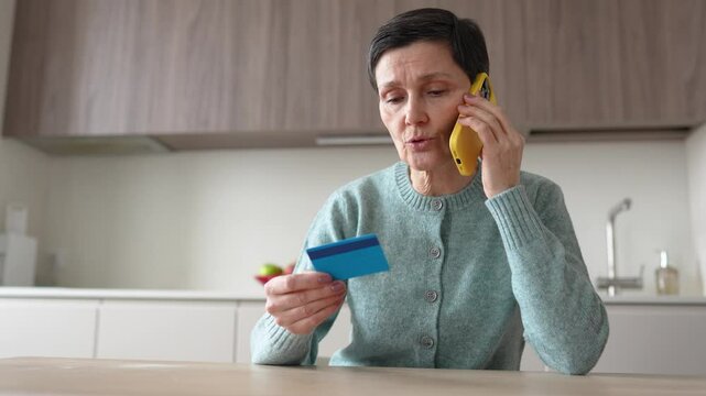 Financial phone scam. Nervous stressed frightened woman sending money to fraudsters via phone. Identity personal data fraud, manipulation, vulnerable target, bank card information, criminal activity