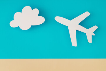 Travel concept made with cloud and plane paper cards on light blue and beige background. Trendy vacation idea. Unique holiday flat lay. Creative copy space. Top view banner.