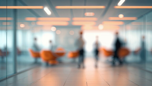Out of focus view of people in modern office space engaging in various business activities.