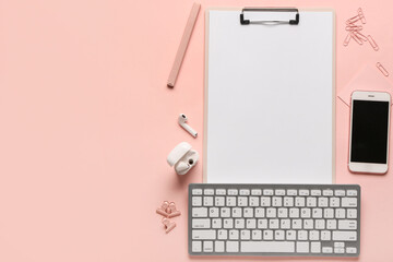 Composition with clipboard, keyboard and phone on pink background. Top view