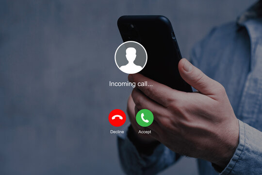 Notification of an incoming call on a smartphone held by a man wearing a shirt.