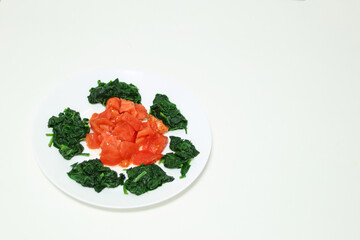 Healthy food. Spinach dish with fresh tomato