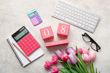 Composition with flowers, notebook, eyeglasses, keyboard, calculators and cube calendar on beige grunge background. International Women's Day celebration