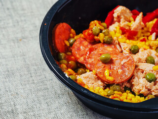 Spanish paella dish with spicy chorizo sausages. Close up. Popular traditional food made of fine rice and other ingredients.