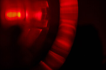Red light leaks on dark background. Abstract background for design with random shapes. Colorful...
