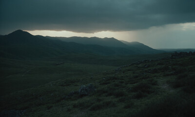 Obraz premium sun peeks through a dark, threatening cloud over rolling hills nature on its glory dark environment a road on a hill is under stormy skies
