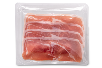 Raw Parma ham slices sealed in clear plastic tray isolated