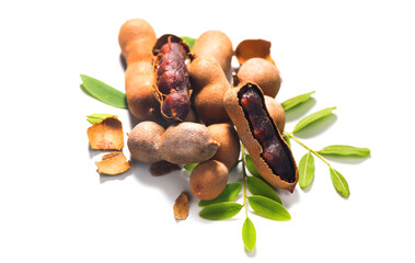 Tamarind tropical fruits isolated on white background. Fresh Tamarind pods with leaves (Tamarindus indica, Indian date), healthy vegan food close up, top view, flat lay. 