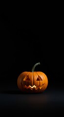 Spooky halloween pumpkin with carved face glowing in darkness for autumn celebration