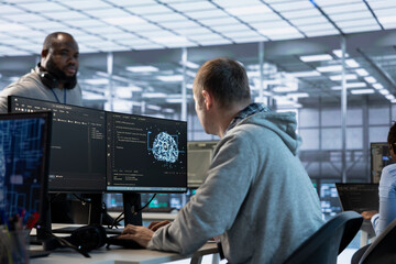 Software developers using machine learning applications to optimize server farm operations. Team of...