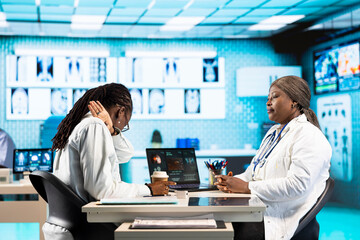Black girl at checkup suffers from respiratory problems and coughing, asking her physician about treatment. General practitioner offers advice on chest inflammation to asthmatic patient.