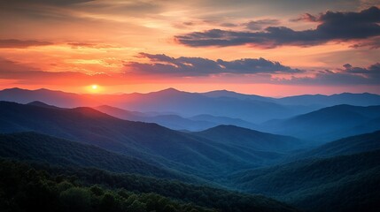 Vibrant sunset over layered blue mountains. (1)