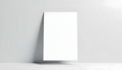 Naklejka premium A blank white A4 paper sheet, floating in the air, casting a soft shadow on a light gray background. The paper is slightly angled, creating a sense of depth and dimension