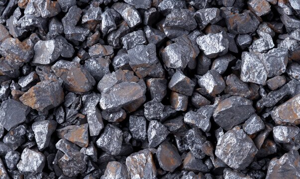 Crushed iron ore background texture. Spherical lumps of crushed ore concentrate close-up. Semi-finished product of metallurgical production of iron. Iron-containing product of pelletizing and roasting
