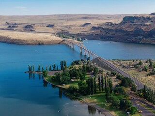 Fototapeta premium Aerial view of the Lyons Ferry Bridge in Washington, USA, spanning the Snake River facilitating transportation. Also Lyons Ferry State Park, Starbuck, Washington, USA