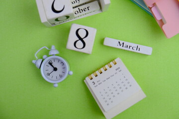 Monthly desk calendar for MARCH 2025 on an office background. 