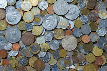 close-up view of different types of coins, large and small, from different countries and different denominations, foreign currency, exchange