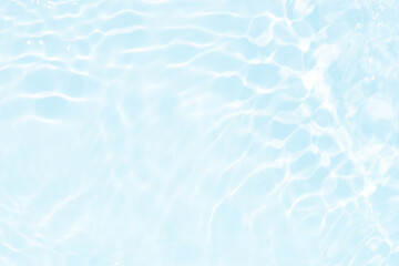 Blue water with ripples on the surface. Defocus blurred transparent blue colored clear calm water surface texture with splashes and bubbles. Water waves with shining pattern texture background.