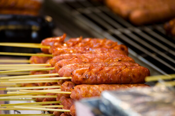 skewers of golden and tempting grilled sausages are neatly arranged