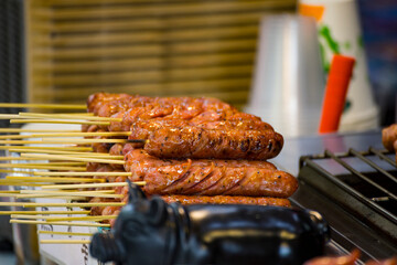 skewers of golden and tempting grilled sausages are neatly arranged