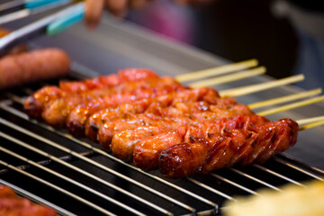 skewers of golden and tempting grilled sausages are neatly arranged