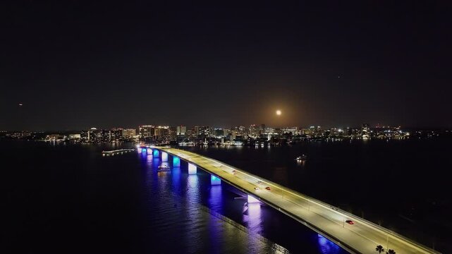 Drone of downtown Sarasota Florida at night over Ringling Causeway Bridge