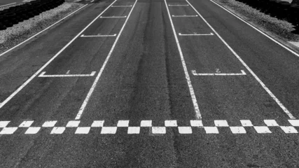 Fototapete Rund Formel 1 Start or finish line on car race, Start and finish line racing, Grid start race track, Top view textured and background grid start on the asphalt road race track abstract.  © Kalyakan