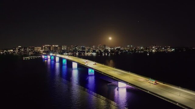 Drone of downtown Sarasota Florida at night over Ringling Causeway Bridge