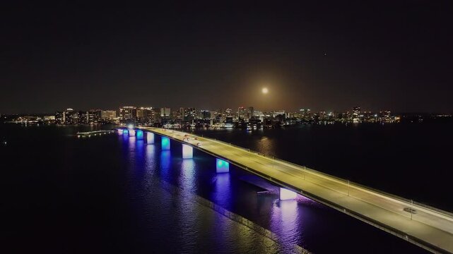 Drone of downtown Sarasota Florida at night over Ringling Causeway Bridge