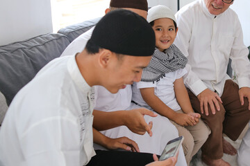 Muslim Family Bonding On Eid Celebration. Multi Generation Family Greeting Others On Video Call.