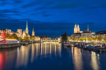 Zurich Switzerland night city skyline at Limmat River with Grossmunster and Fraumunster Church