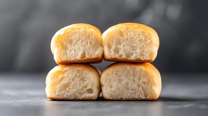 Freshly Baked Soft Dinner Rolls Stacked Neatly on Gray Background for Culinary and Baking Themes