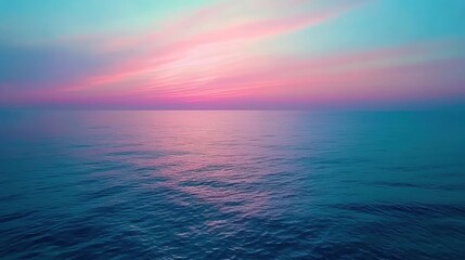 Fototapeta premium A serene sunset over the ocean with a distant boat silhouetted against the colorful sky.